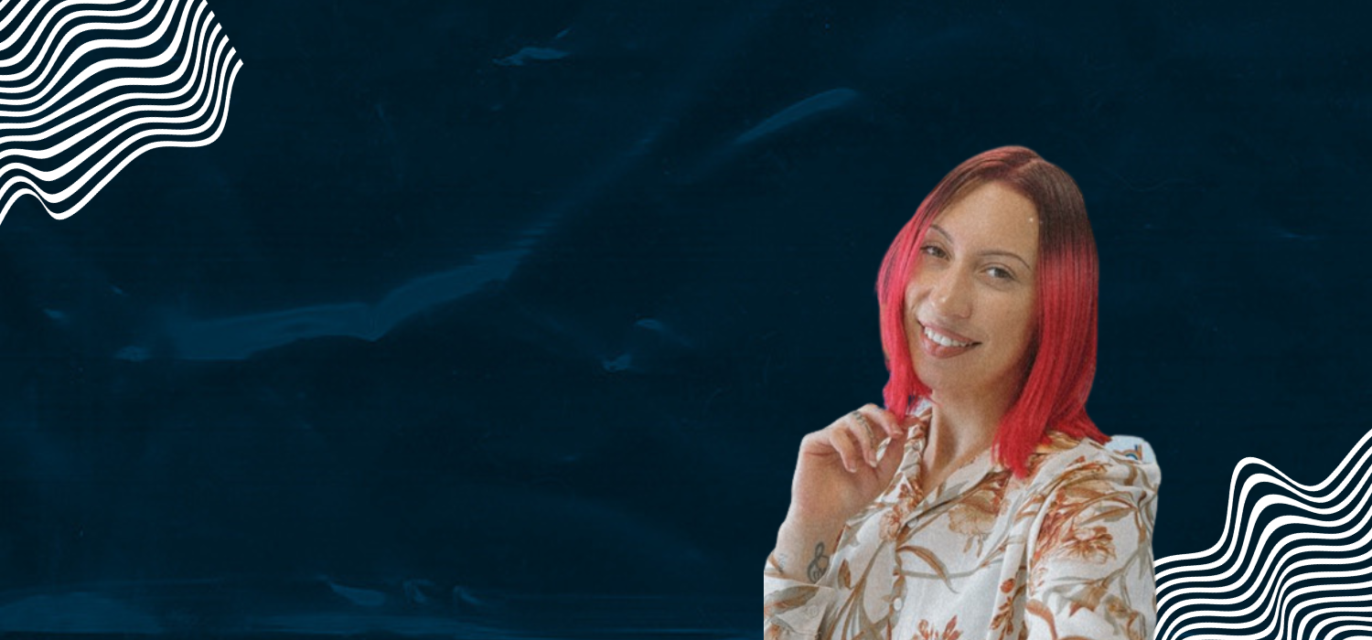A woman with long hair against a blue background.
